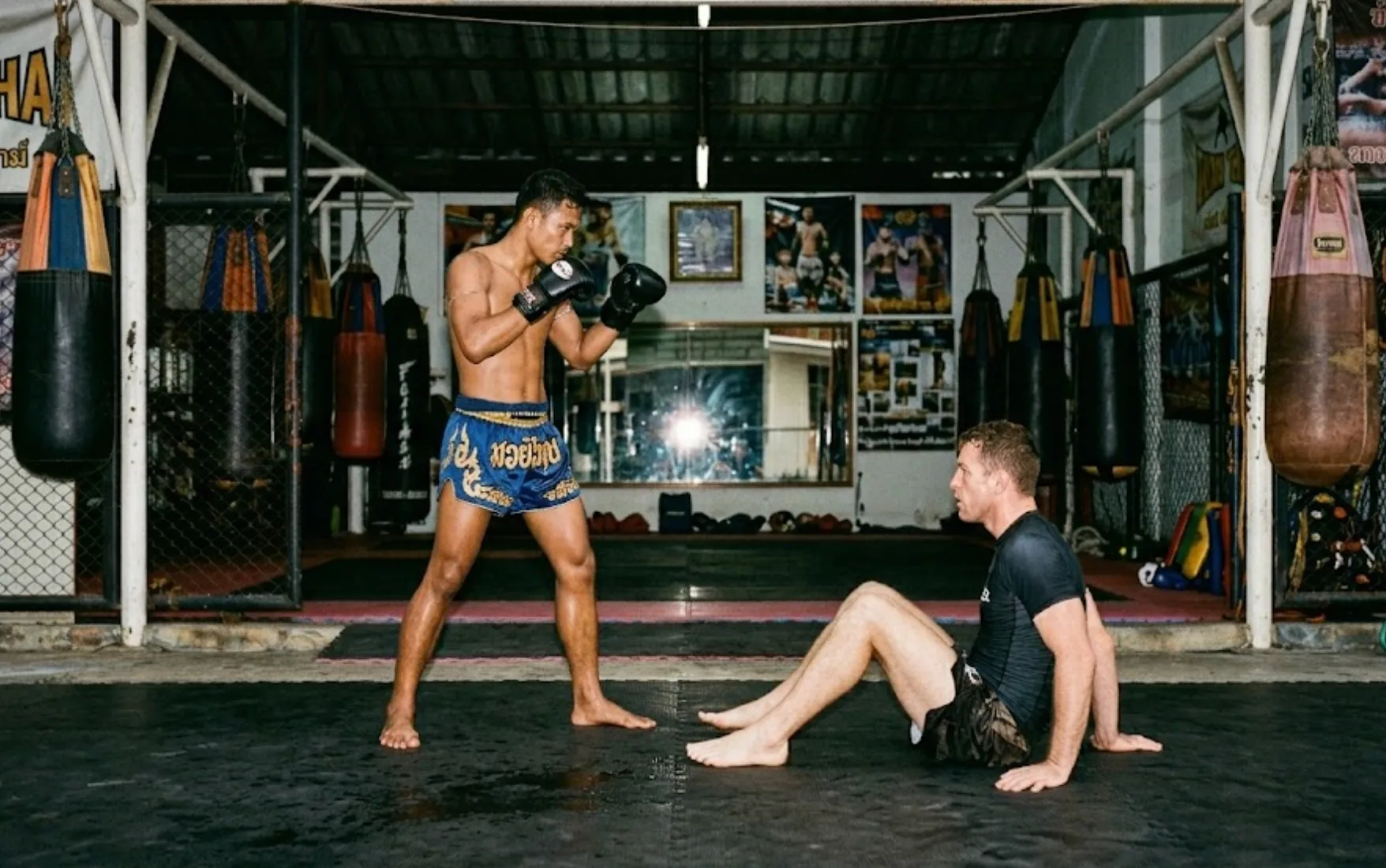 Muay Thai vs Brazilian jiu-jitsu — two fighters representing each art