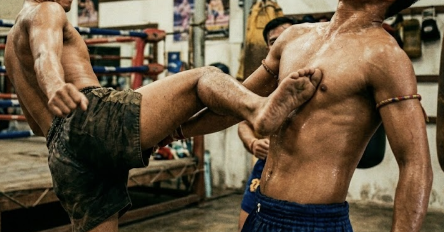 Muay Thai fighter throwing a roundhouse kick in training