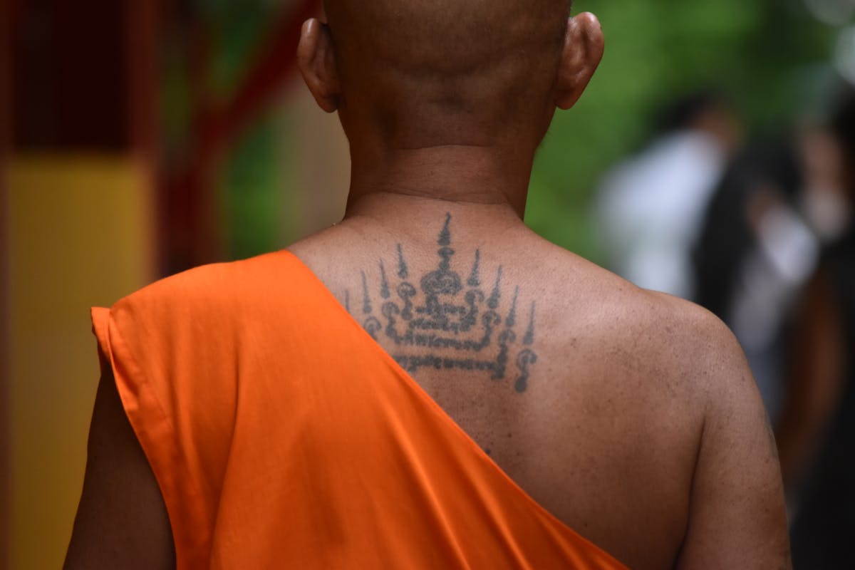 Buddhist monk with sacred tattoos, Bangkok temple