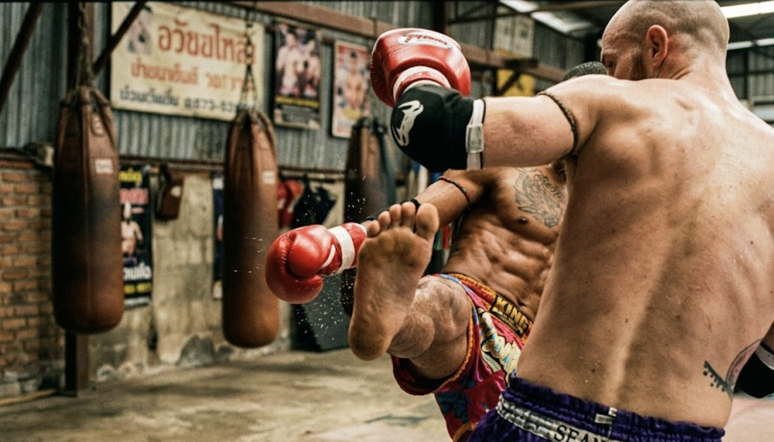 Muay Thai fighter drilling the teep in training