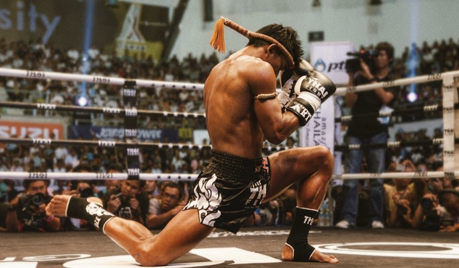 Muay Thai fighter performing the Wai Kru in the ring, Thailand